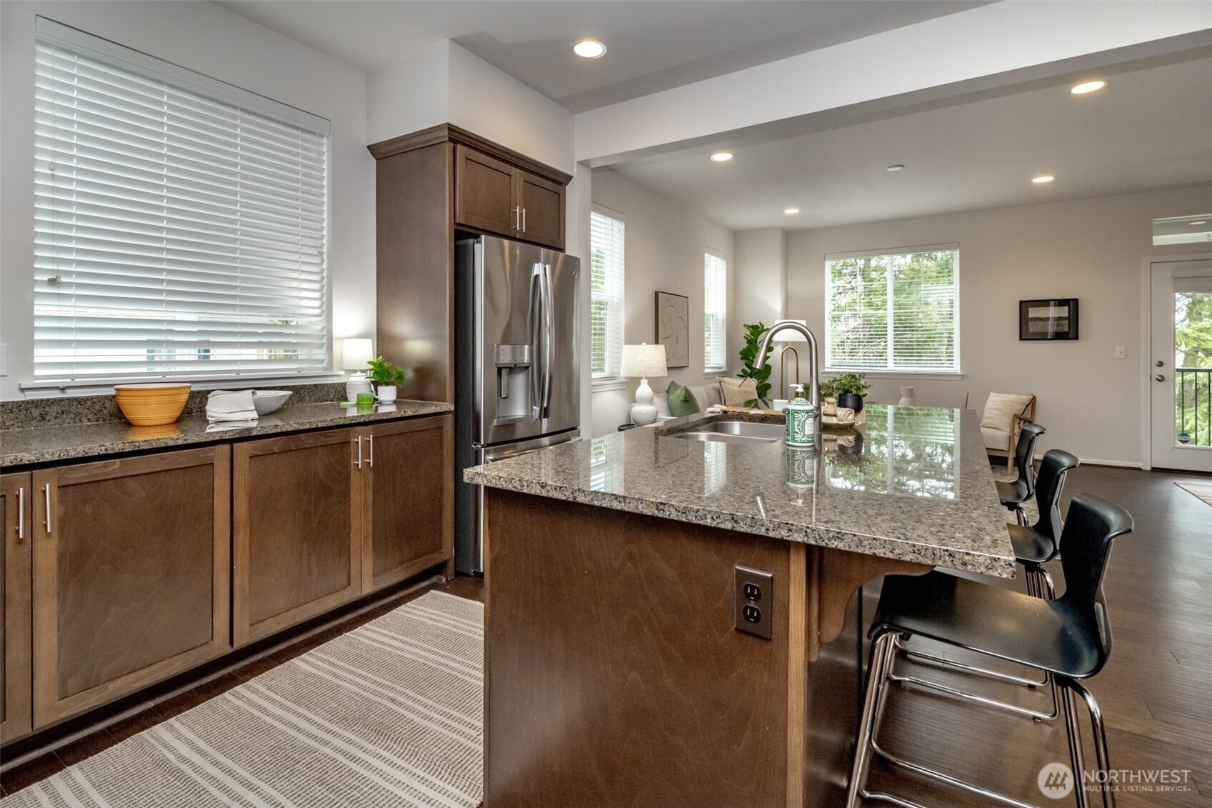 6830 31st Avenue Southwest Seattle, WA 98126 - Photo 11 of 28 a kitchen with stainless steel appliances granite countertop sink stove and refrigerator