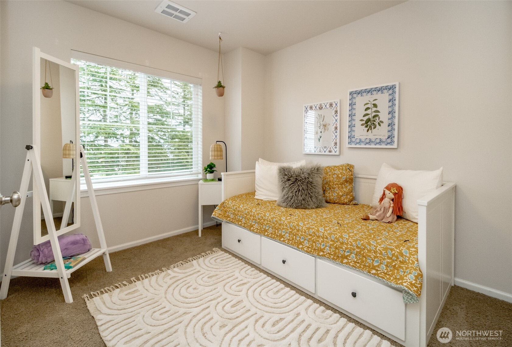 6830 31st Avenue Southwest Seattle, WA 98126 - Photo 22 of 28 a bed sitting in a bedroom next to a window