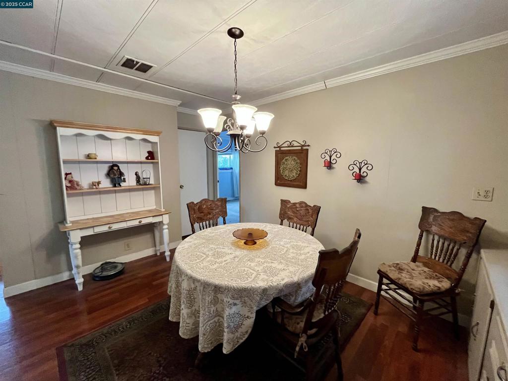 189 Cairo Drive Pacheco, CA 94553 - Photo 8 of 15 a dining room with furniture a chandelier and wooden floor