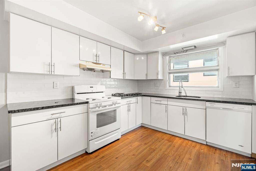 24 East Ruby Avenue, Unit 2 Palisades Park, NJ 07650 - Photo 1 of 19 a kitchen with granite countertop white cabinets and white appliances