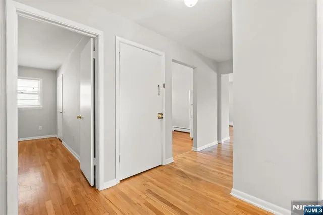 a view of hallway with wooden floor