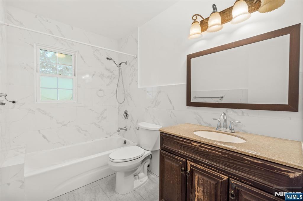 24 East Ruby Avenue, Unit 2 Palisades Park, NJ 07650 - Photo 17 of 19 a bathroom with a sink a toilet and shower