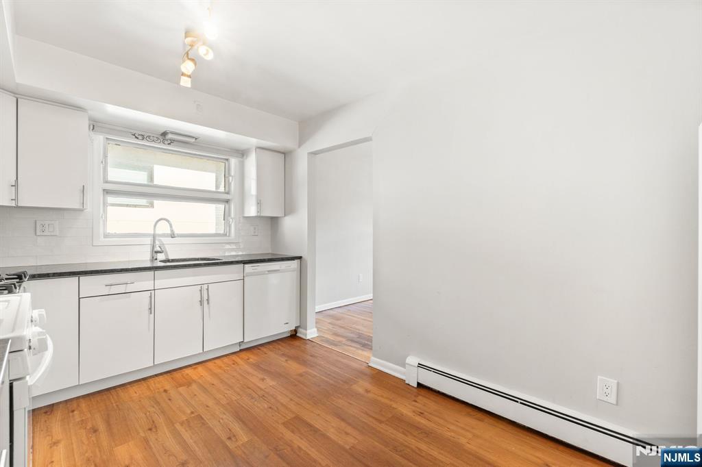 24 East Ruby Avenue, Unit 2 Palisades Park, NJ 07650 - Photo 2 of 19 a kitchen with granite countertop white cabinets and white appliances