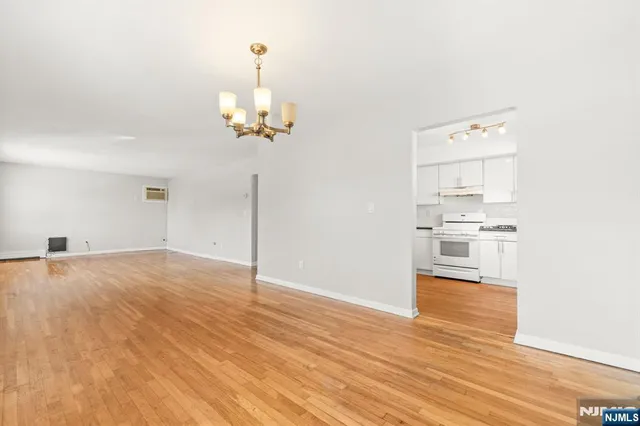a view of a kitchen with wooden floor and a kitchen