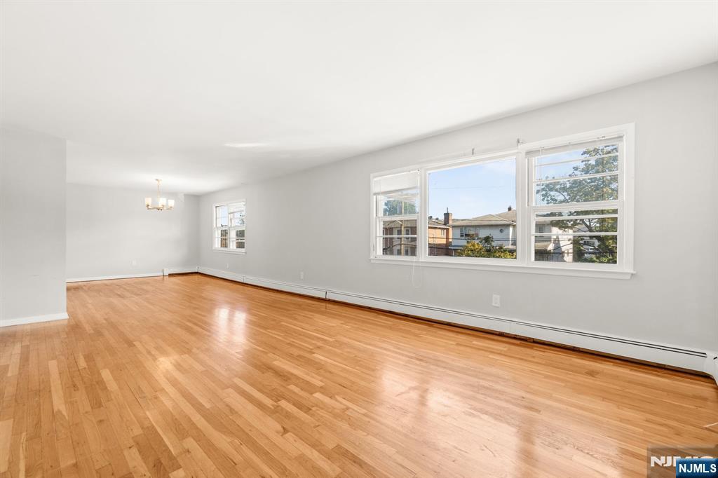 24 East Ruby Avenue, Unit 2 Palisades Park, NJ 07650 - Photo 6 of 19 a view of empty room with wooden floor and fan