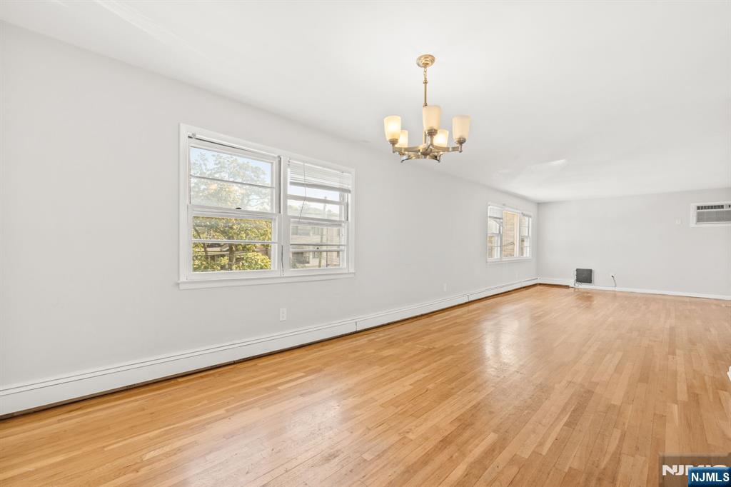 24 East Ruby Avenue, Unit 2 Palisades Park, NJ 07650 - Photo 8 of 19 wooden floor in an empty room with a window