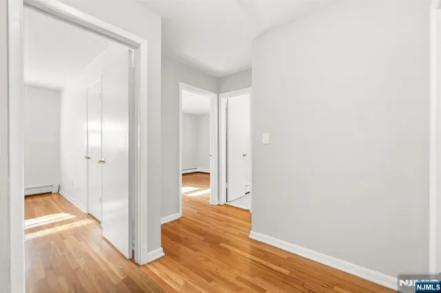 a view of a room with wooden floor