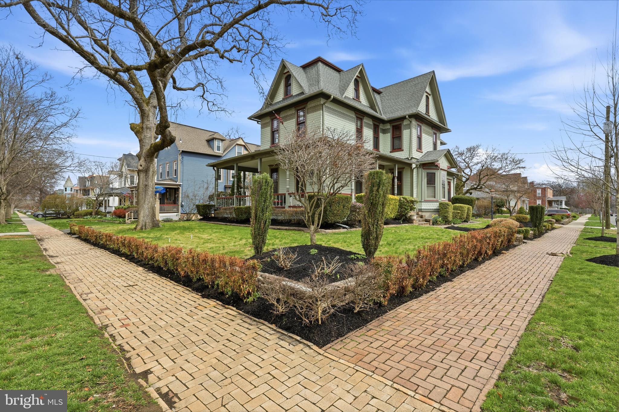 323 Washington Avenue Haddonfield, NJ 08033 - Photo 2 of 57 a front view of a house with a yard and potted plants