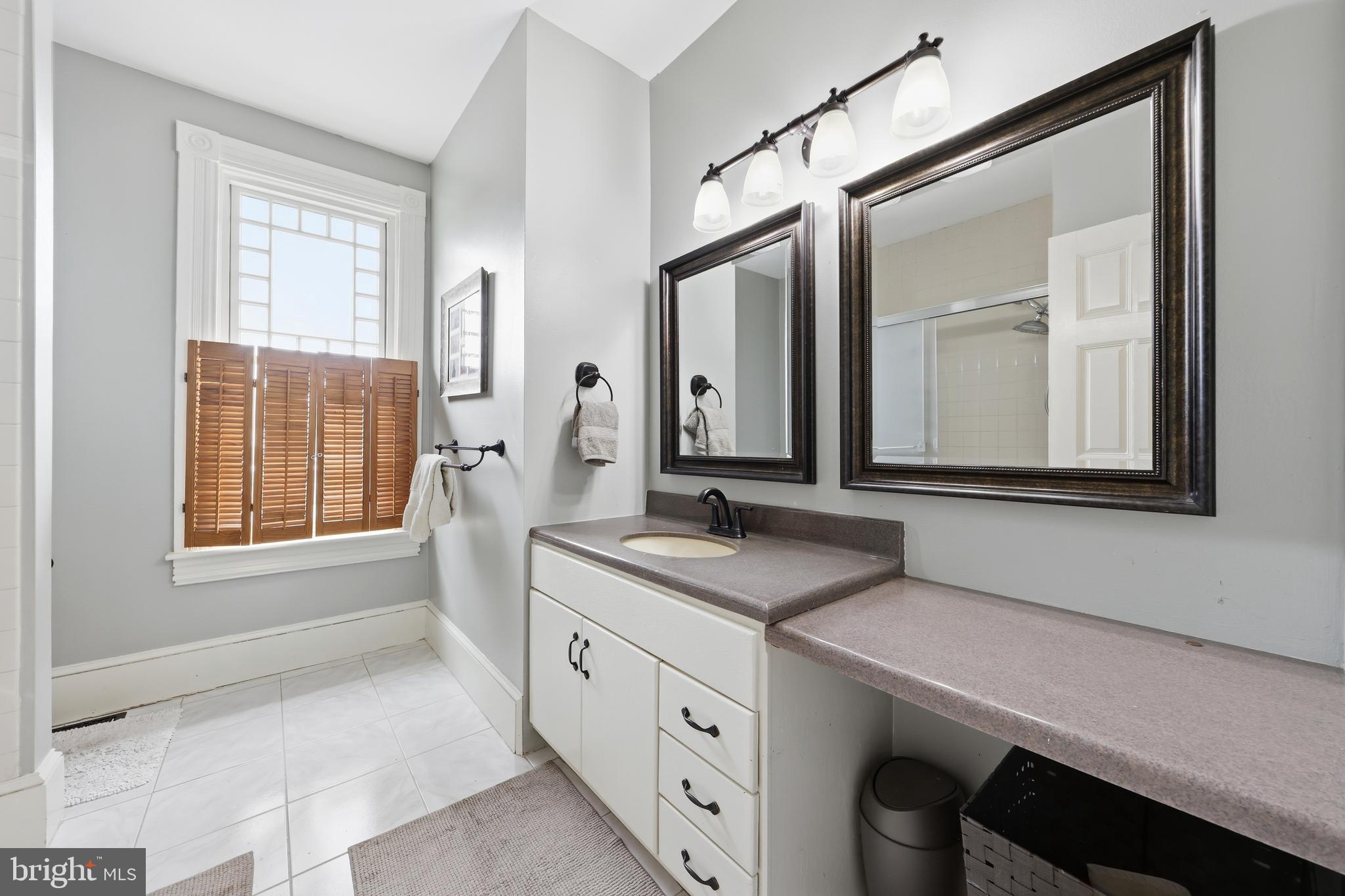 323 Washington Avenue Haddonfield, NJ 08033 - Photo 46 of 57 a spacious bathroom with a granite countertop sink and a mirror