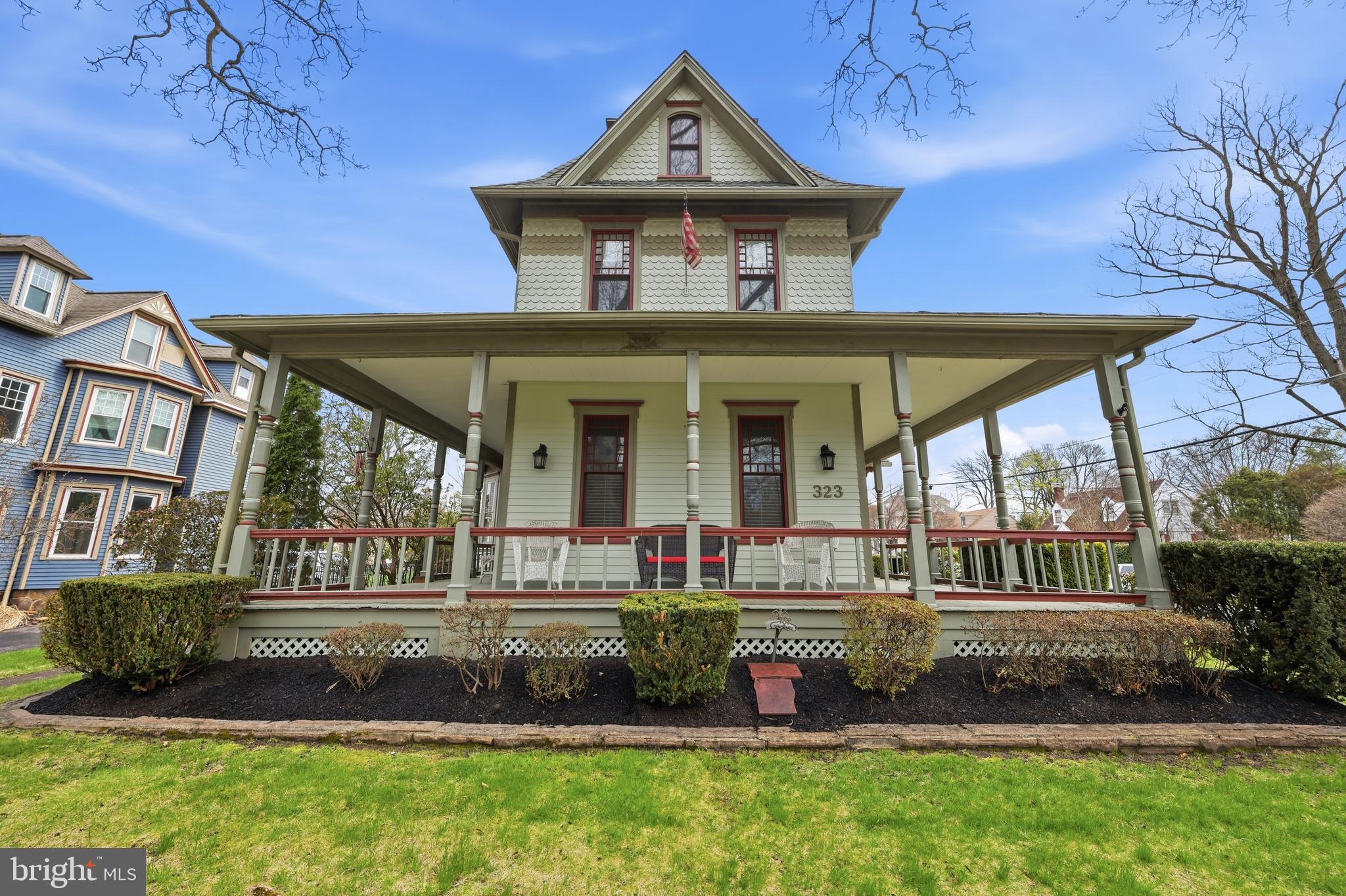 323 Washington Avenue Haddonfield, NJ 08033 - Photo 5 of 57 a front view of a house with a yard table and chairs