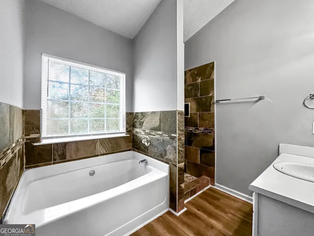 a bathroom with a bathtub and a shower
