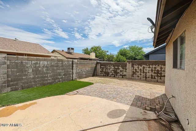 a view of a backyard with wooden fence