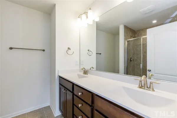 a bathroom with a double vanity sink and a mirror