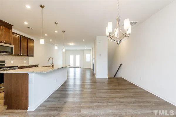 a view of a kitchen with a sink stainless steel appliances and cabinets