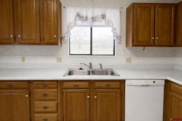 a kitchen with sink cabinets and window