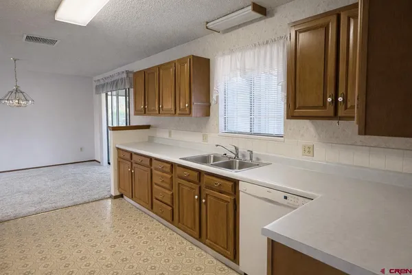 a kitchen with a sink cabinets and window