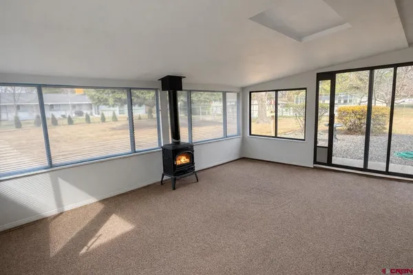 an empty room with sliding glass door and mountain view
