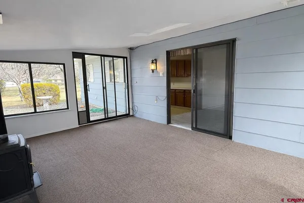 an empty room with windows and closet