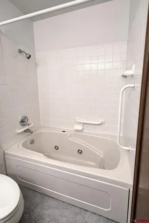 a bathroom with a white bath tub and a shower
