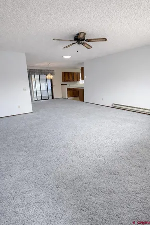 a view of a livingroom with furniture and a ceiling fan