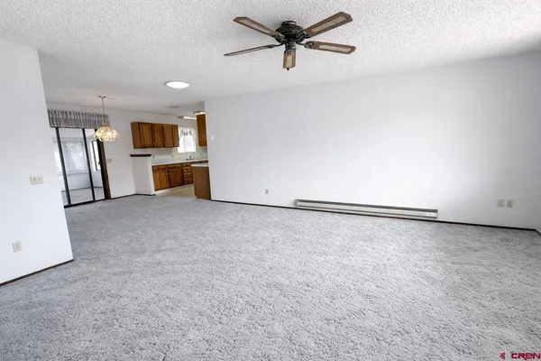 a view of a livingroom with an oven and a refrigerator