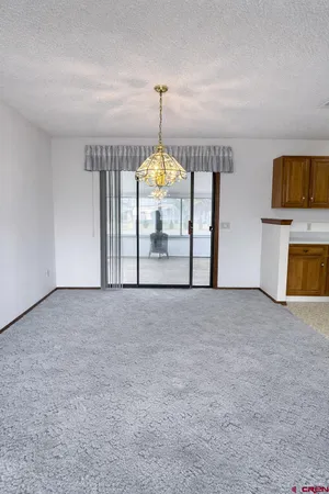 a view of an empty room with window and fire place