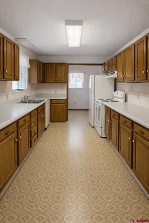 a large kitchen with a stove top oven sink and cabinets
