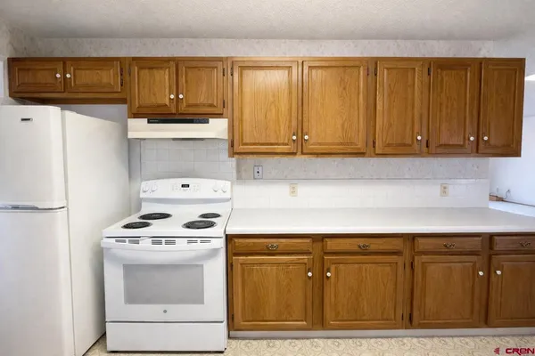 a kitchen with a stove and a refrigerator