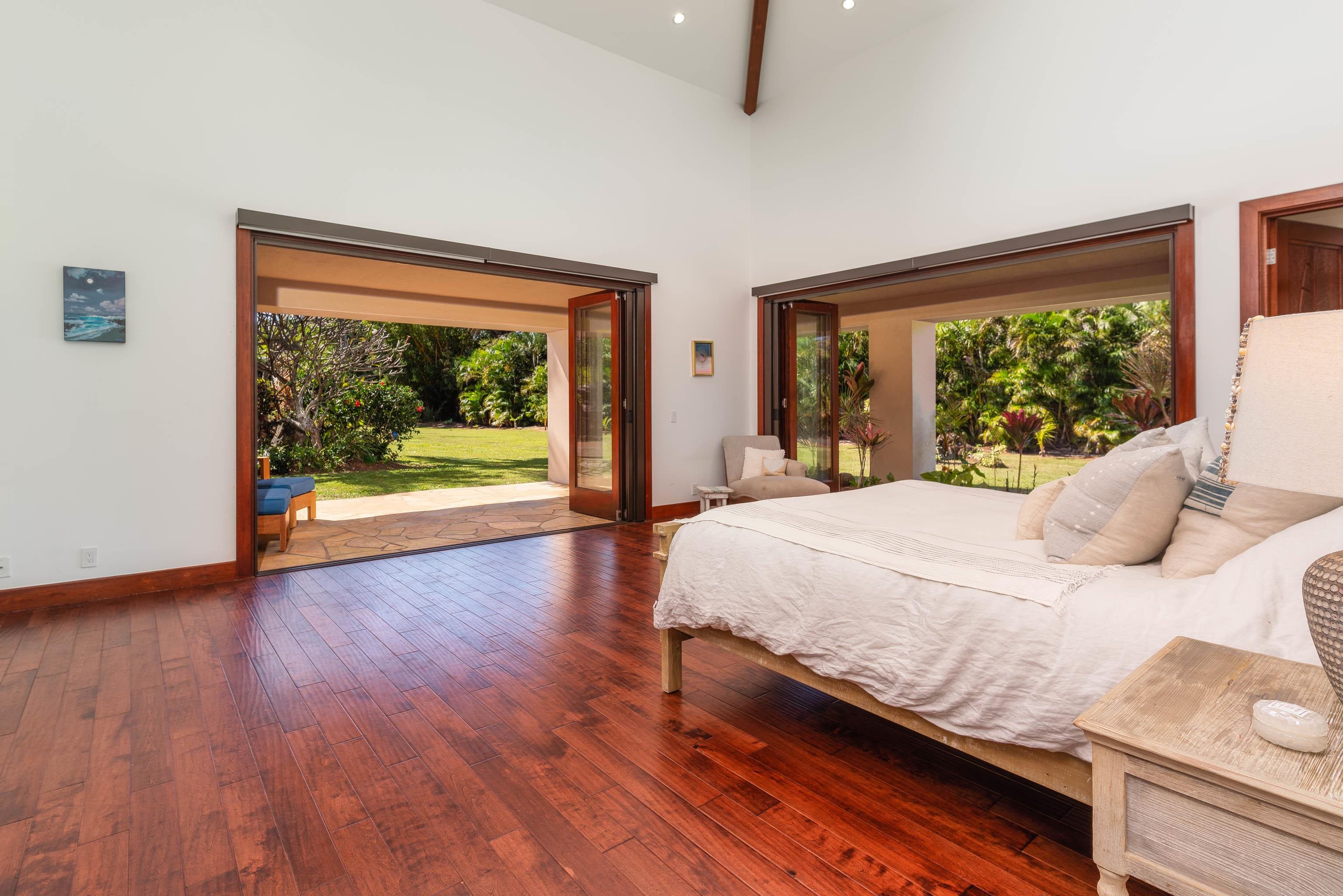 166 Apuwai Street Haiku, HI 96708 - Photo 11 of 30 a bedroom with a bed and wooden floor