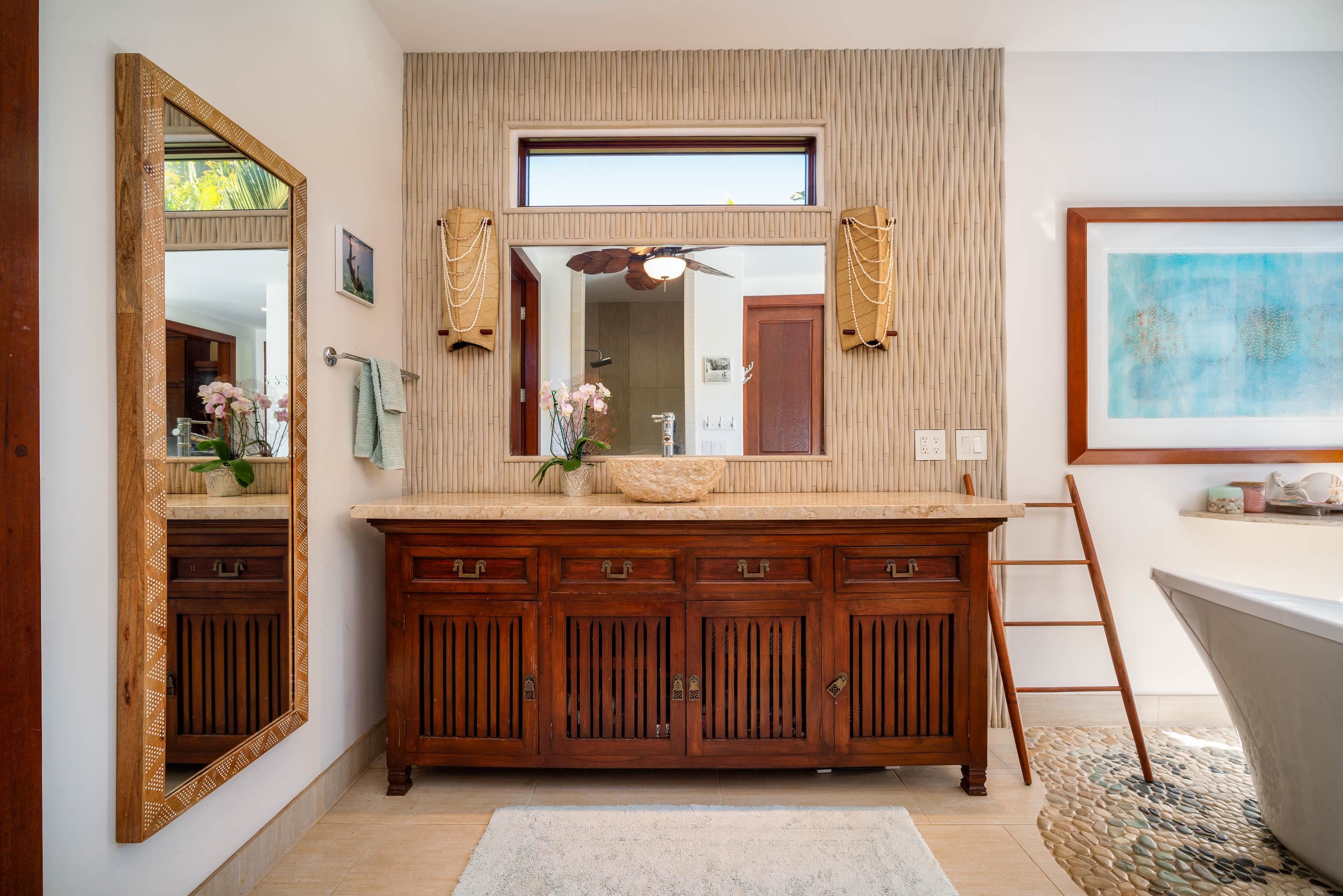 166 Apuwai Street Haiku, HI 96708 - Photo 13 of 30 a bathroom with a sink a vanity and a large mirror
