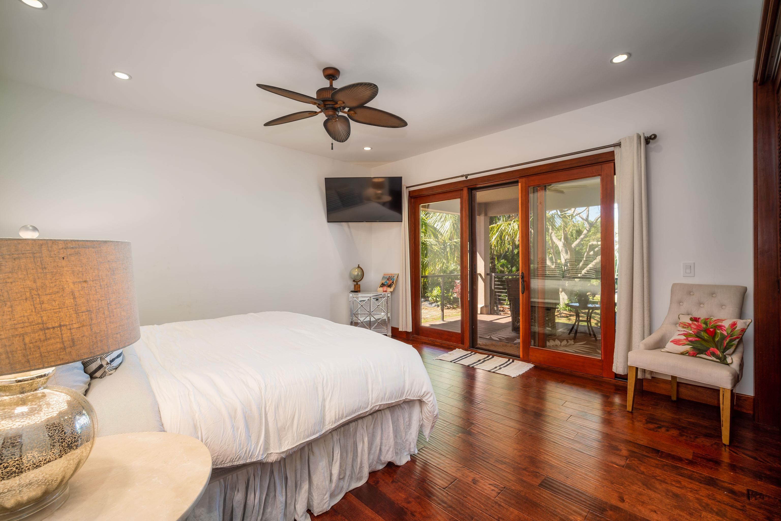 166 Apuwai Street Haiku, HI 96708 - Photo 22 of 30 a bedroom with a large bed and a large window