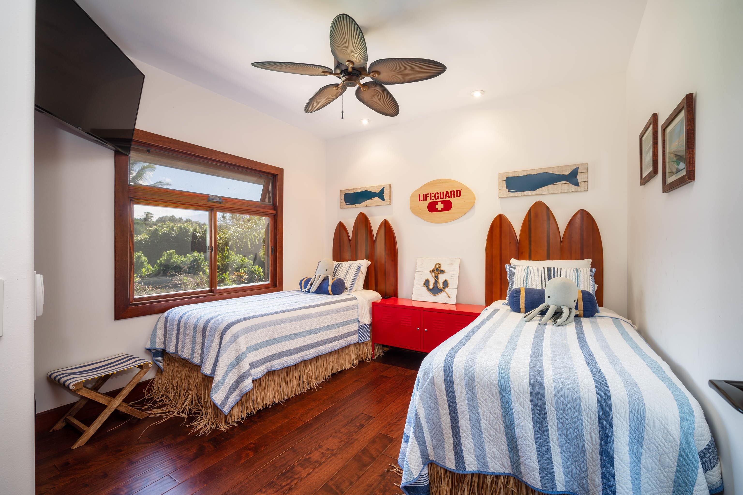 166 Apuwai Street Haiku, HI 96708 - Photo 24 of 30 a bedroom with a bed and a chandelier