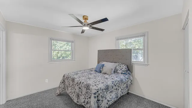 a bedroom with a large bed and a window
