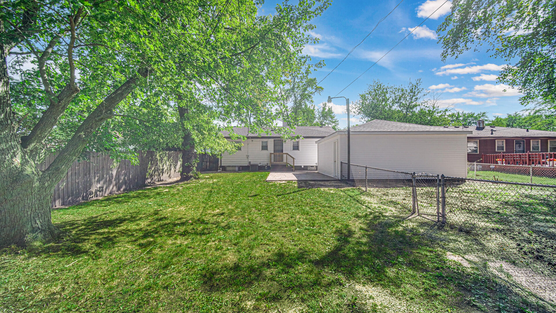 4440 East 13th Place Gary, IN 46403 - Photo 22 of 25 a view of a backyard with plants and large tree