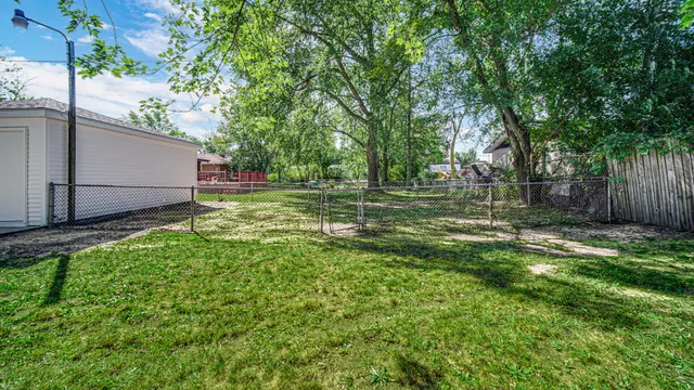 a view of a backyard with large trees