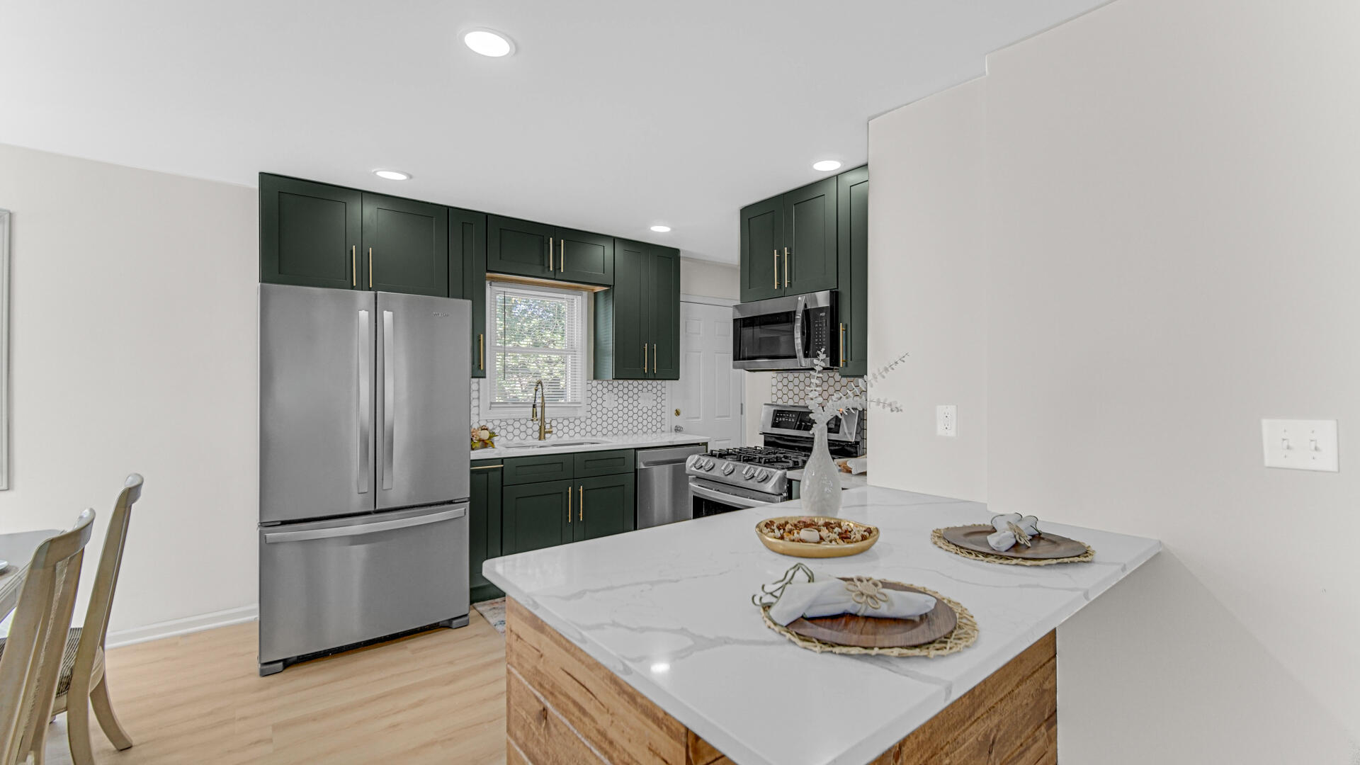 4440 East 13th Place Gary, IN 46403 - Photo 5 of 25 a kitchen with stainless steel appliances granite countertop a sink stove and refrigerator
