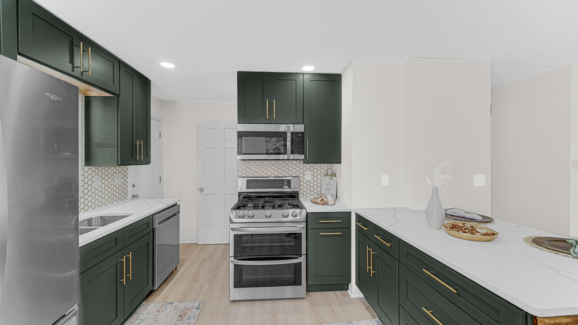 4440 East 13th Place Gary, IN 46403 - Photo 6 of 25 a kitchen with stainless steel appliances a stove and a sink