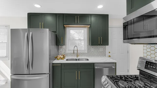 a kitchen with stainless steel appliances a refrigerator and a sink