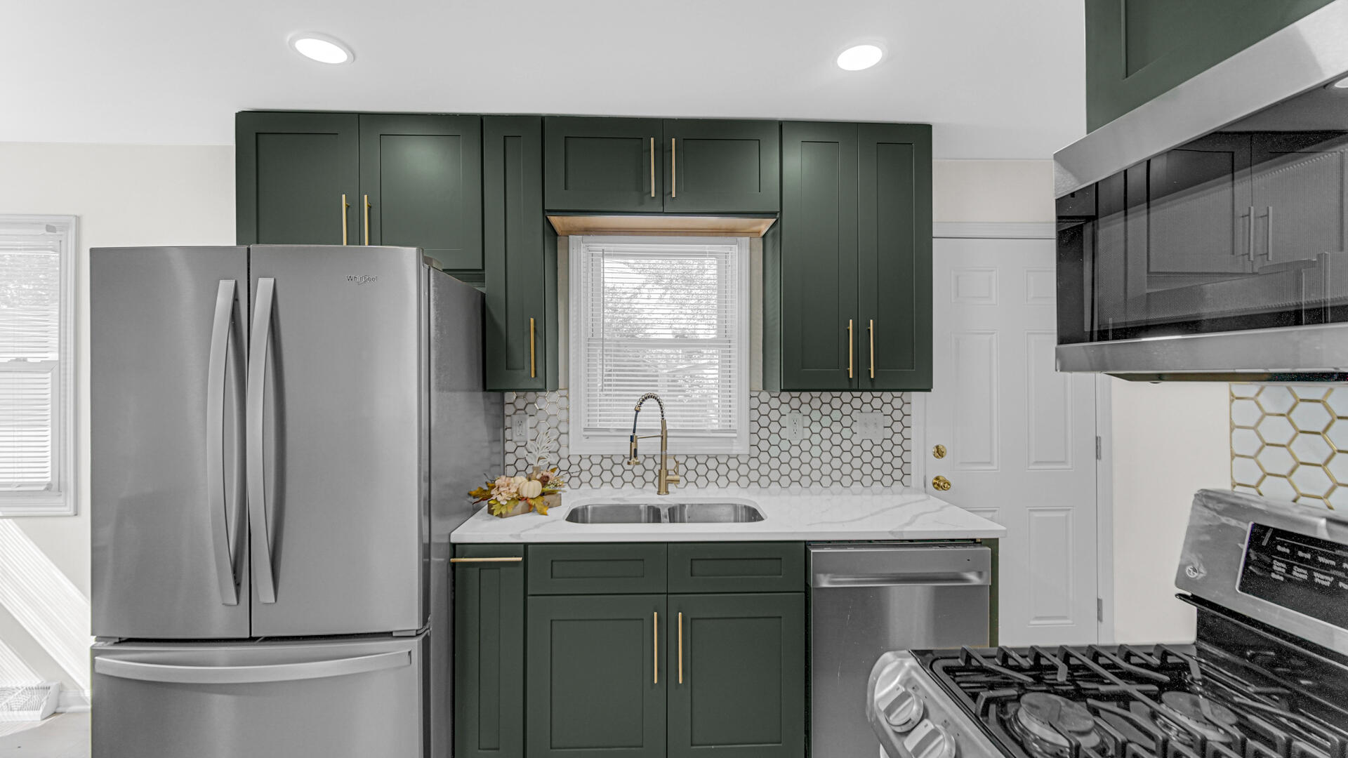 4440 East 13th Place Gary, IN 46403 - Photo 7 of 25 a kitchen with stainless steel appliances a refrigerator and a sink