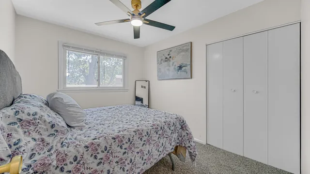 a bedroom with a large bed and a window