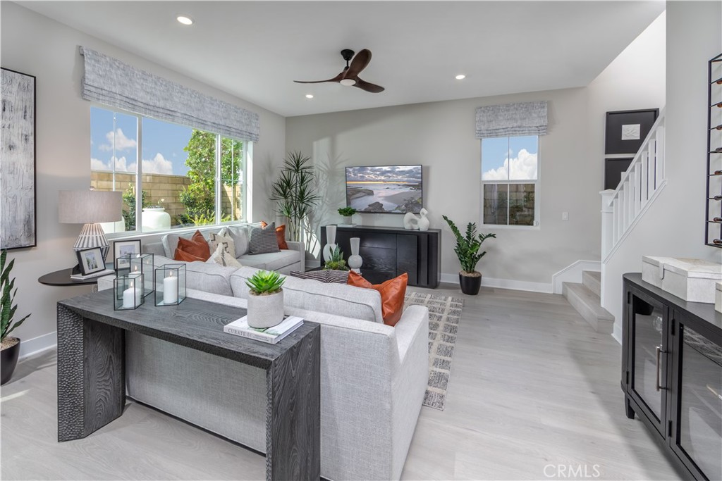 224 Lily Loop Irvine, CA 92618 - Photo 11 of 13 a living room with furniture a fireplace and a large window