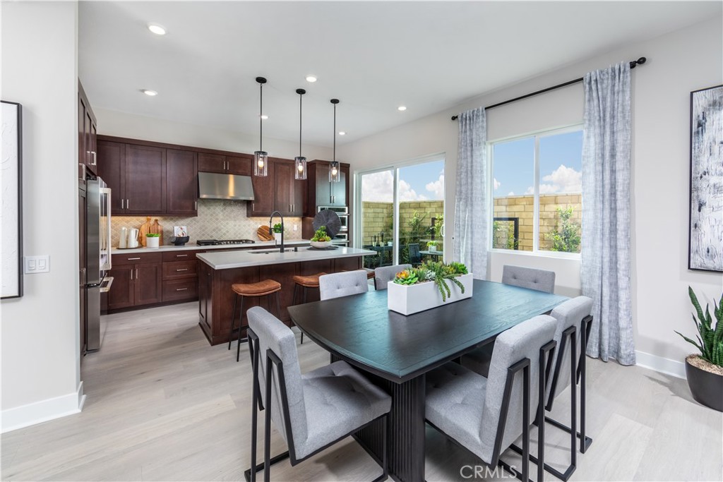 224 Lily Loop Irvine, CA 92618 - Photo 10 of 13 a kitchen with a dining table chairs and refrigerator