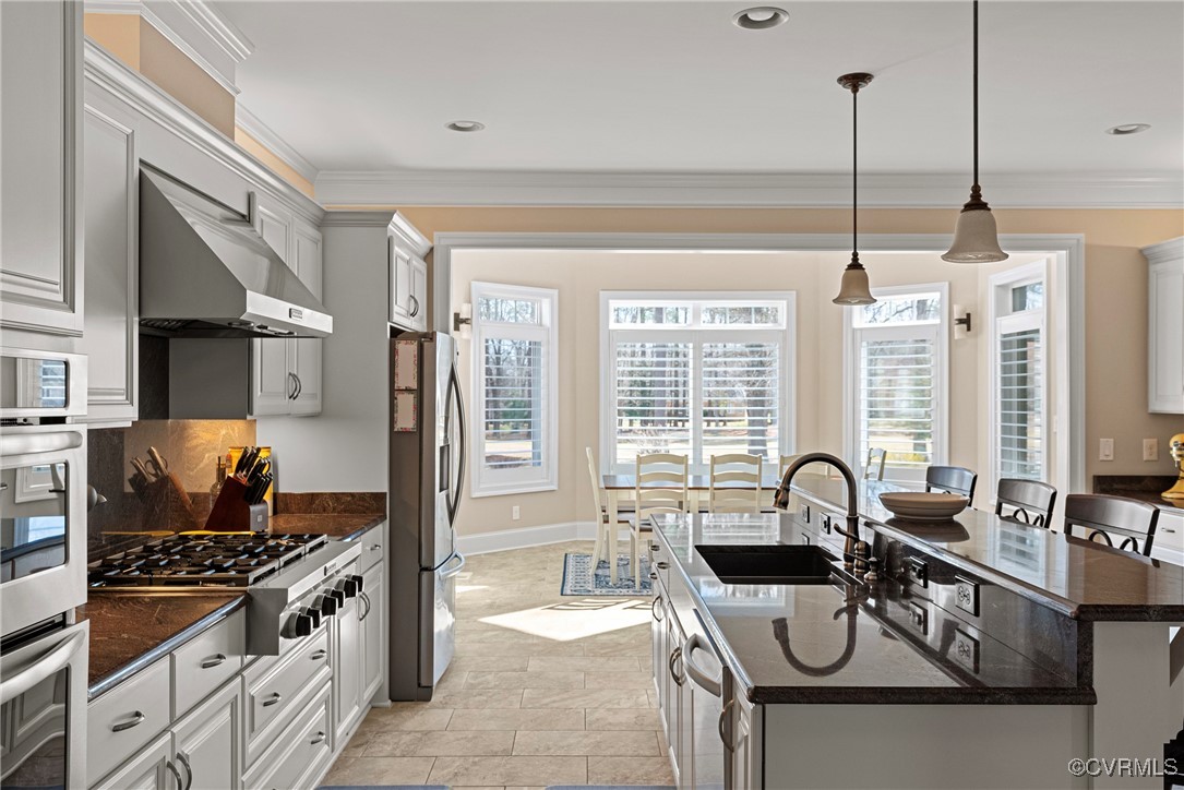 14424 Riverside Drive Ashland, VA 23005 - Photo 7 of 40 Kitchen with crown molding, an island with sink, s