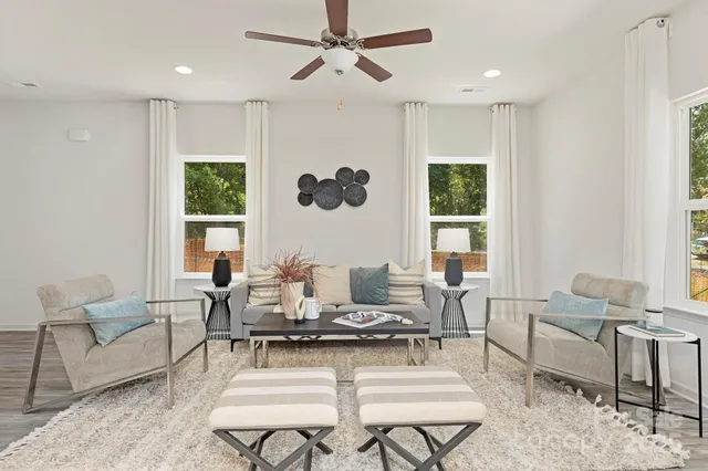 a living room with furniture potted plant and a window
