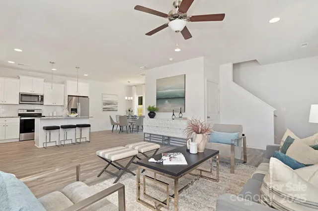 a living room with furniture and kitchen view