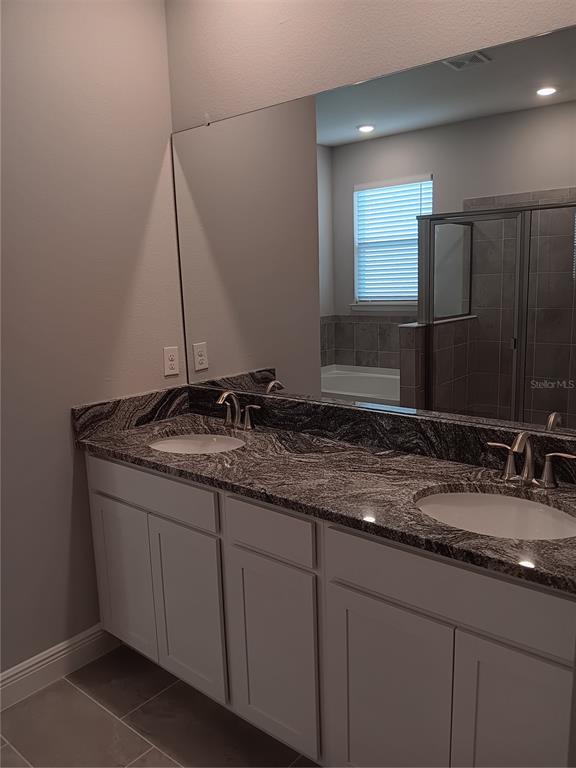 5433 Southwest 44th Ct Road Ocala, FL 34474 - Photo 11 of 24 a bathroom with a granite countertop sink and a mirror