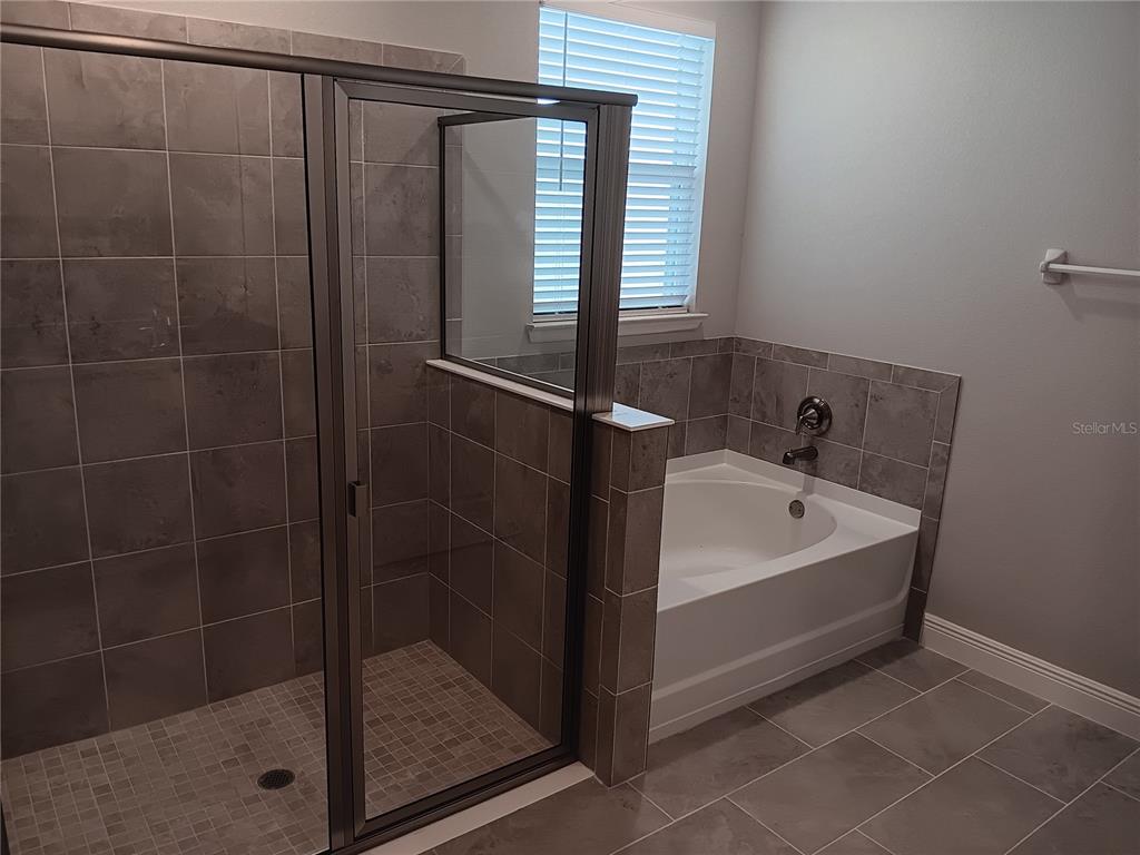 5433 Southwest 44th Ct Road Ocala, FL 34474 - Photo 12 of 24 a bathroom with a bathtub and a shower