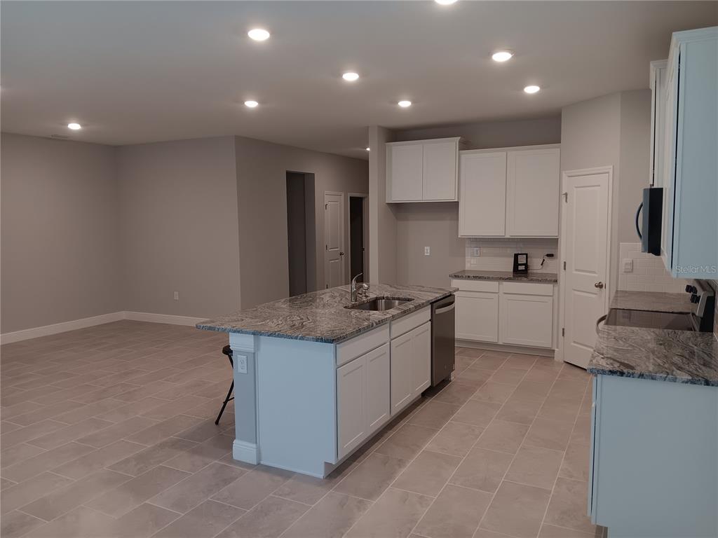 5433 Southwest 44th Ct Road Ocala, FL 34474 - Photo 4 of 24 a kitchen with a sink stove and cabinets