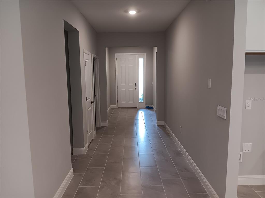 5433 Southwest 44th Ct Road Ocala, FL 34474 - Photo 6 of 24 a view of a hallway with wooden floor