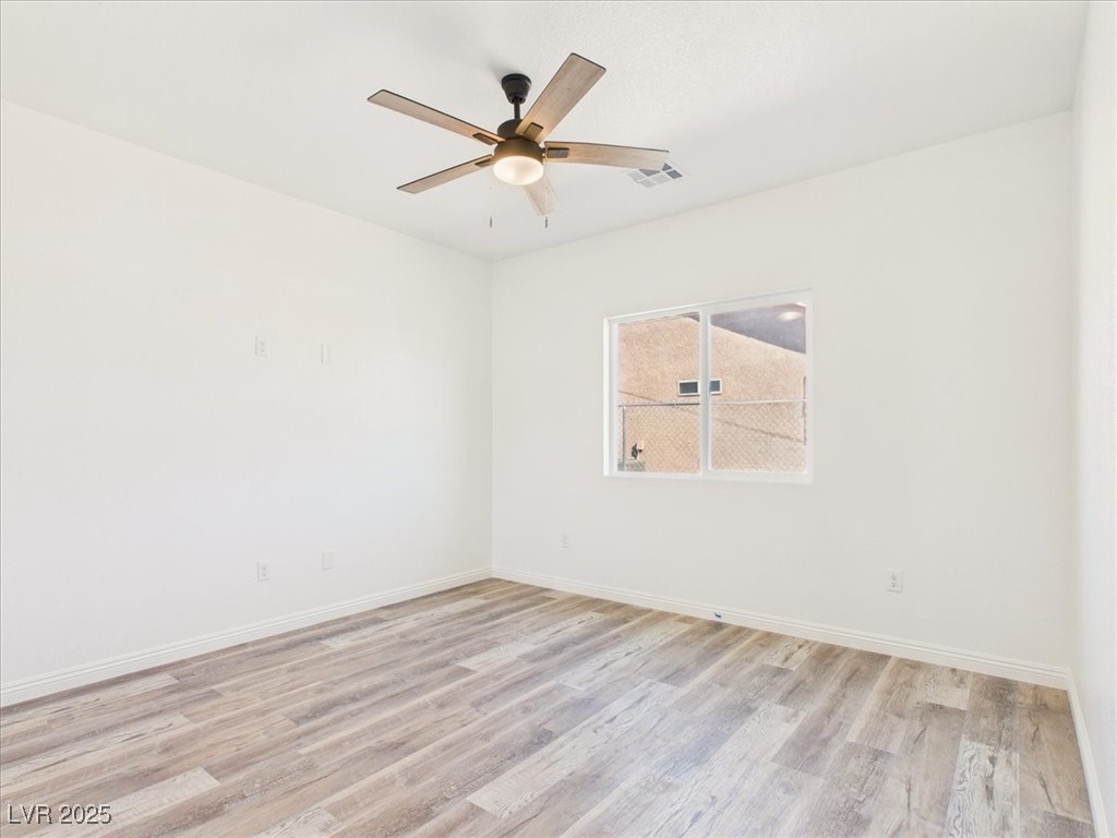 931 Lone Pine Road Pahrump, NV 89048 - Photo 13 of 48 Empty room featuring light wood-style floors and a ceiling fan